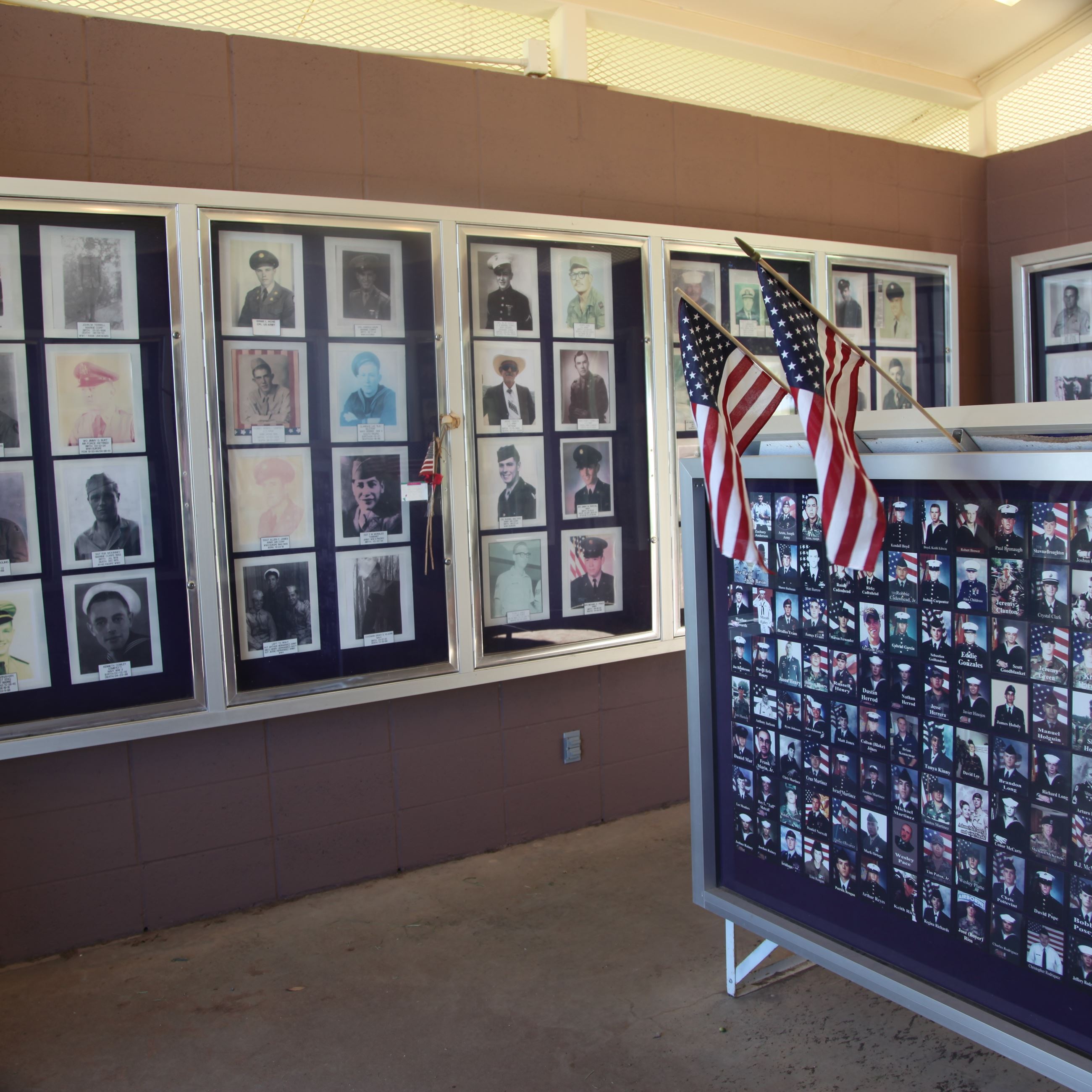 Interior view of Big Spring Vietnam Memorial pavilion showcasing display cases with photographs and 